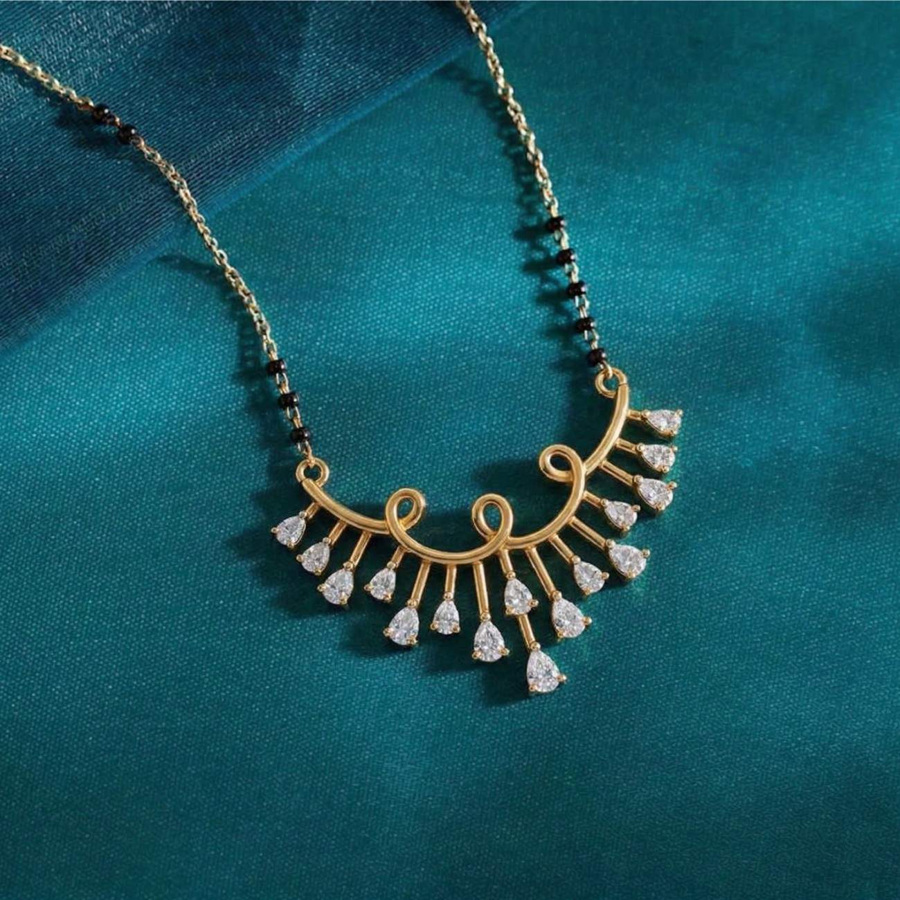 Yellow gold & diamond floral mangalsutra on blue background