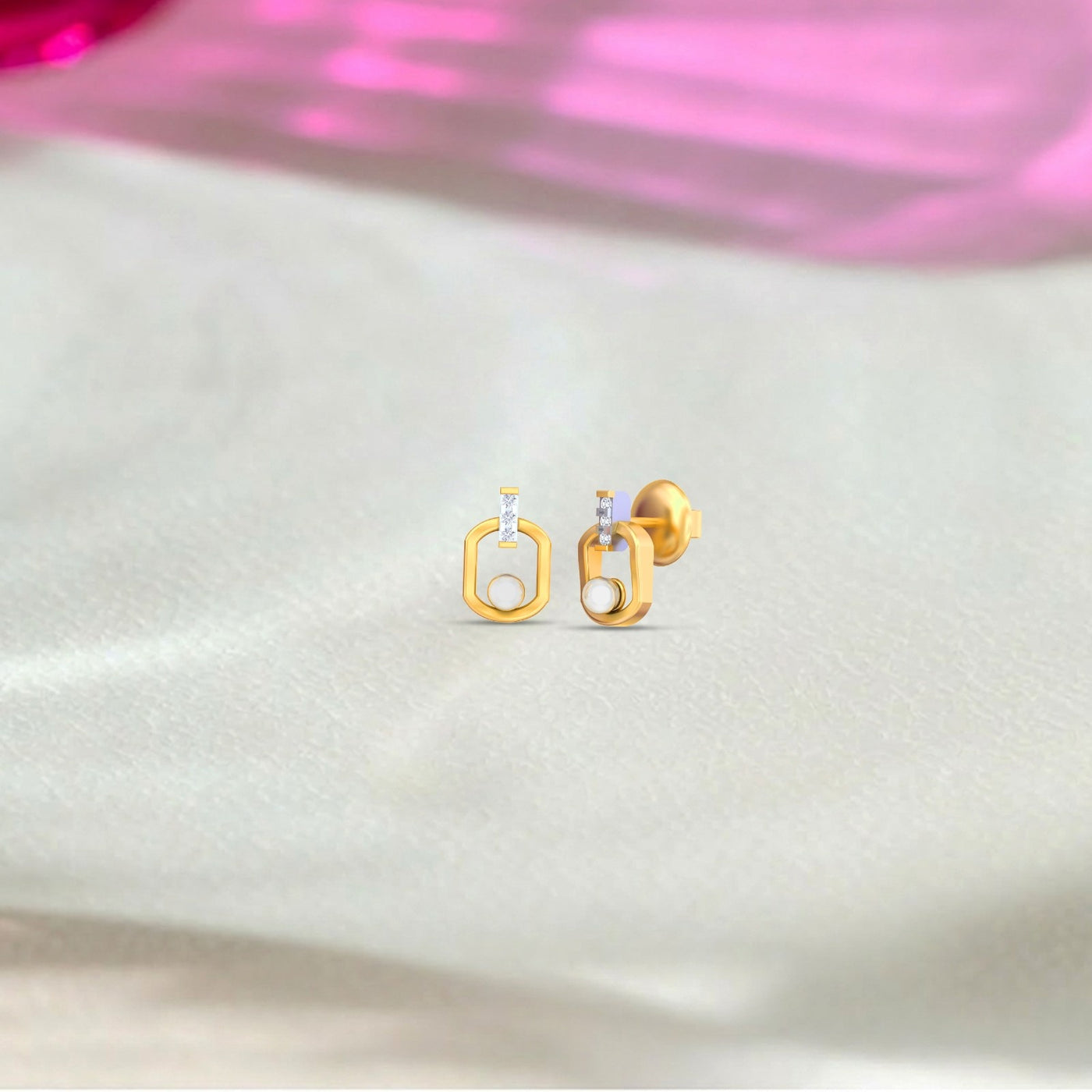 Gold and diamond stud earring on a fabric backgound.