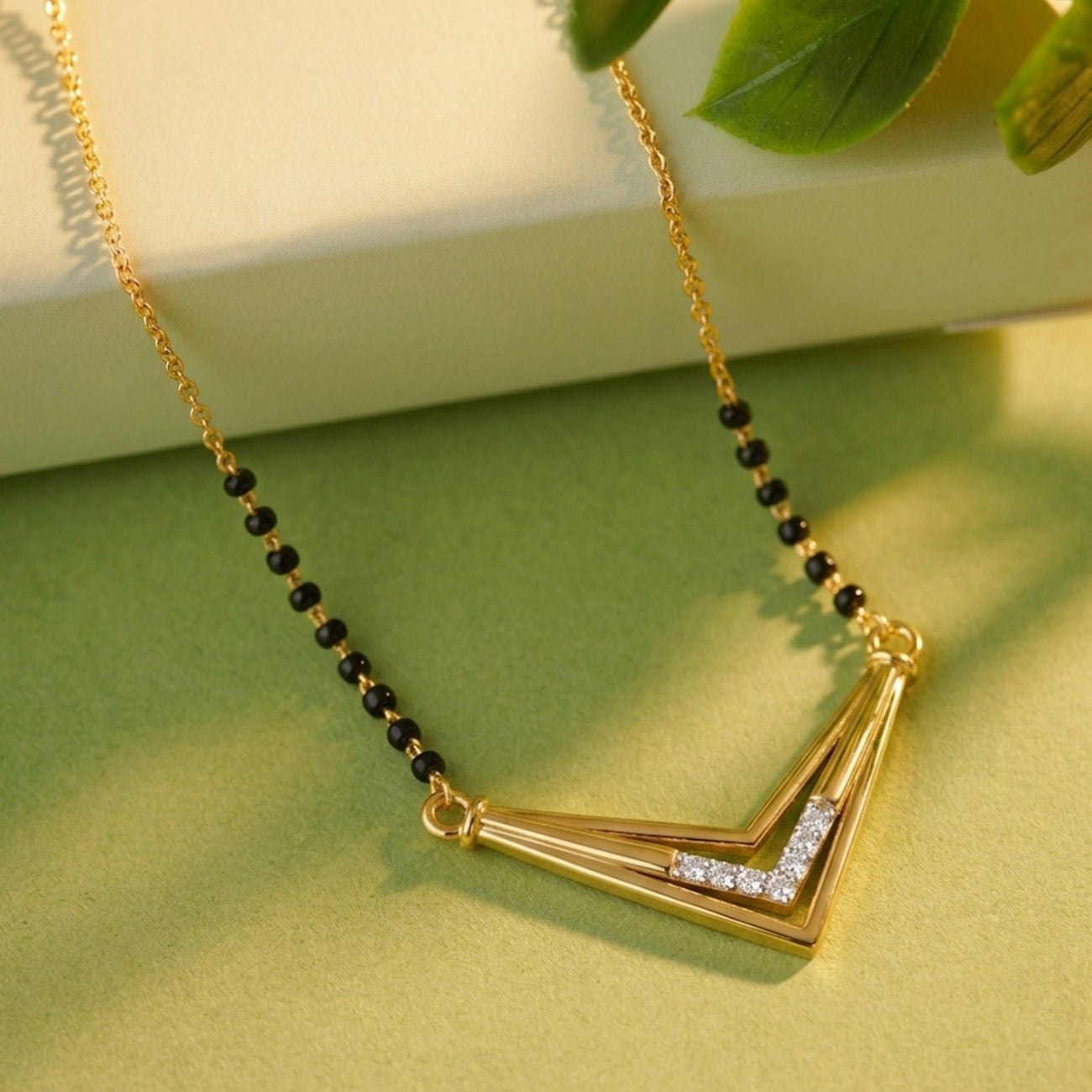  Gold & Diamond Modern Mangalsutra on green Background
