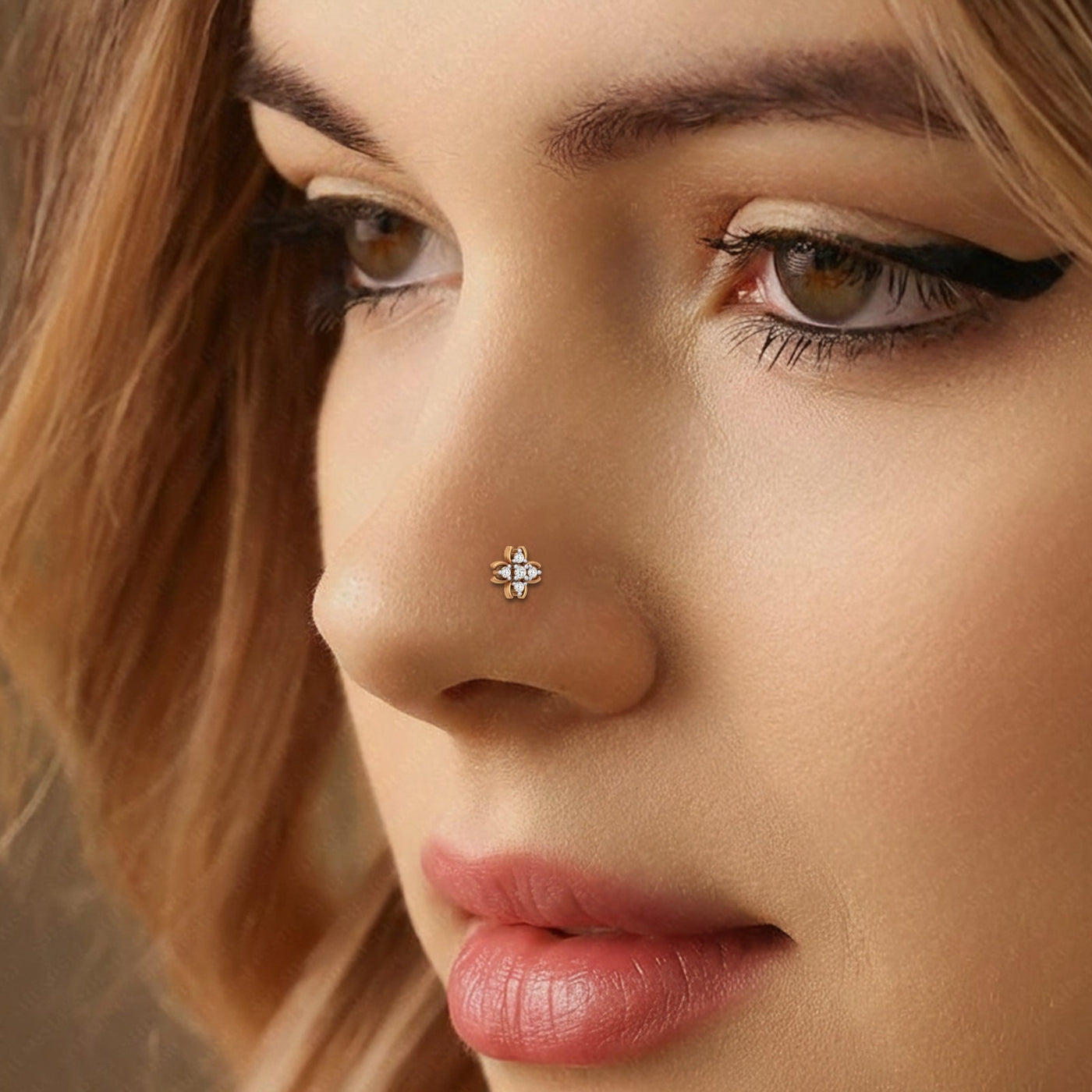 Close-up of a woman's face with a nose pin, soft focus on background