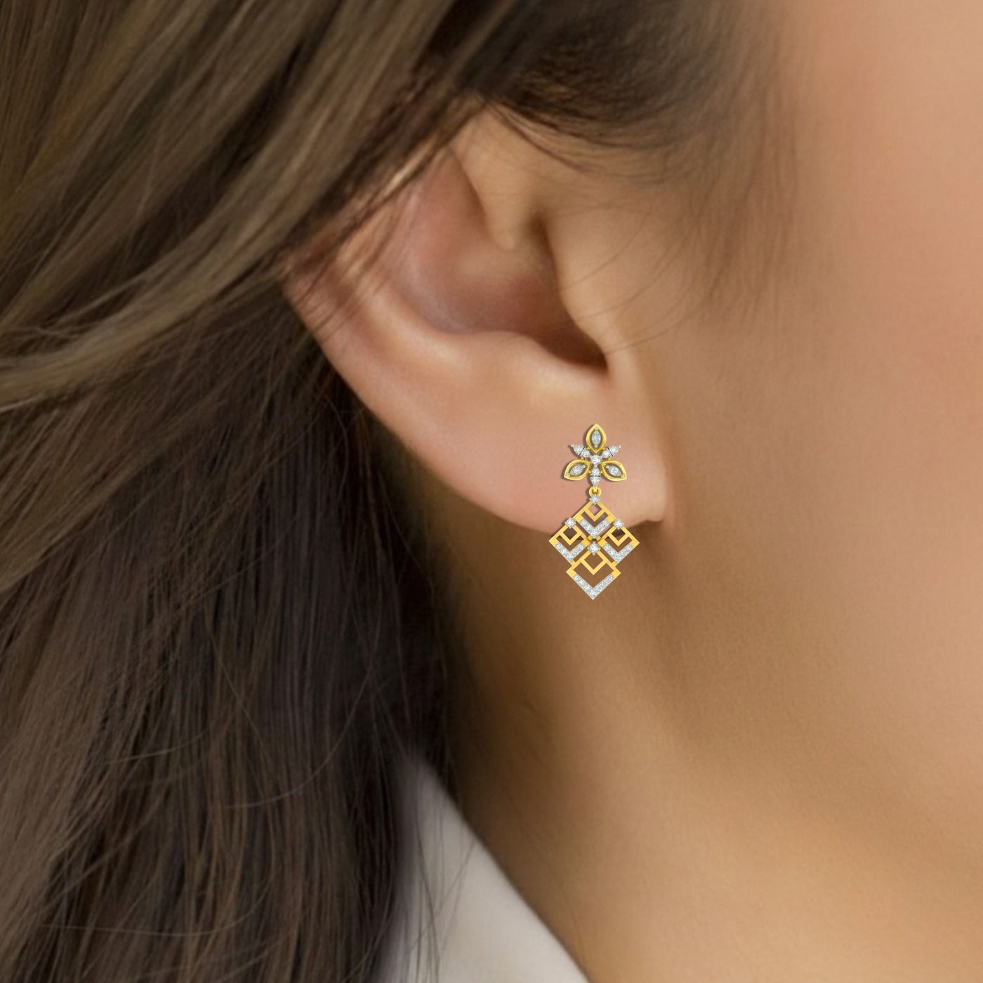 Close-up shot of a gold & diamond geometric floral women dangler earrings with openwork diamond design in yellow gold
