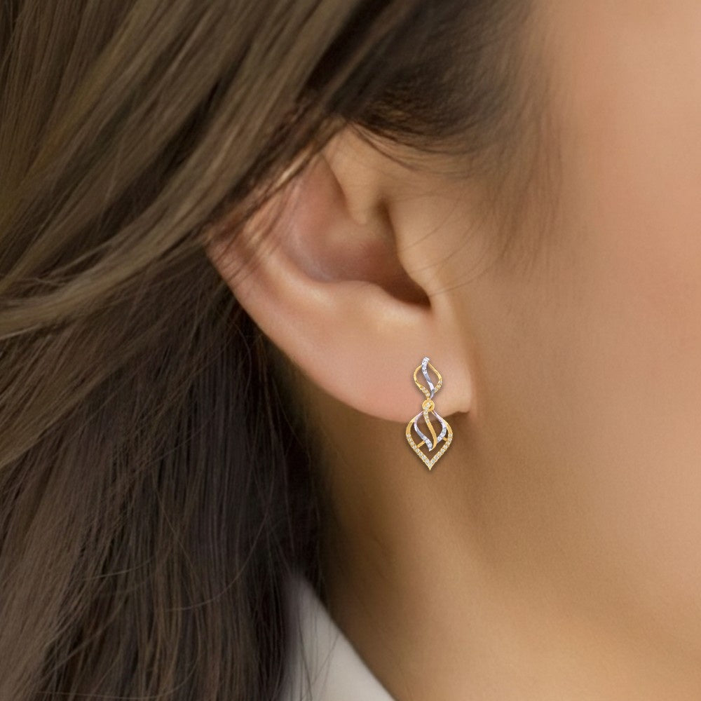 Close-up shot of a gold and diamond dangler earrings.