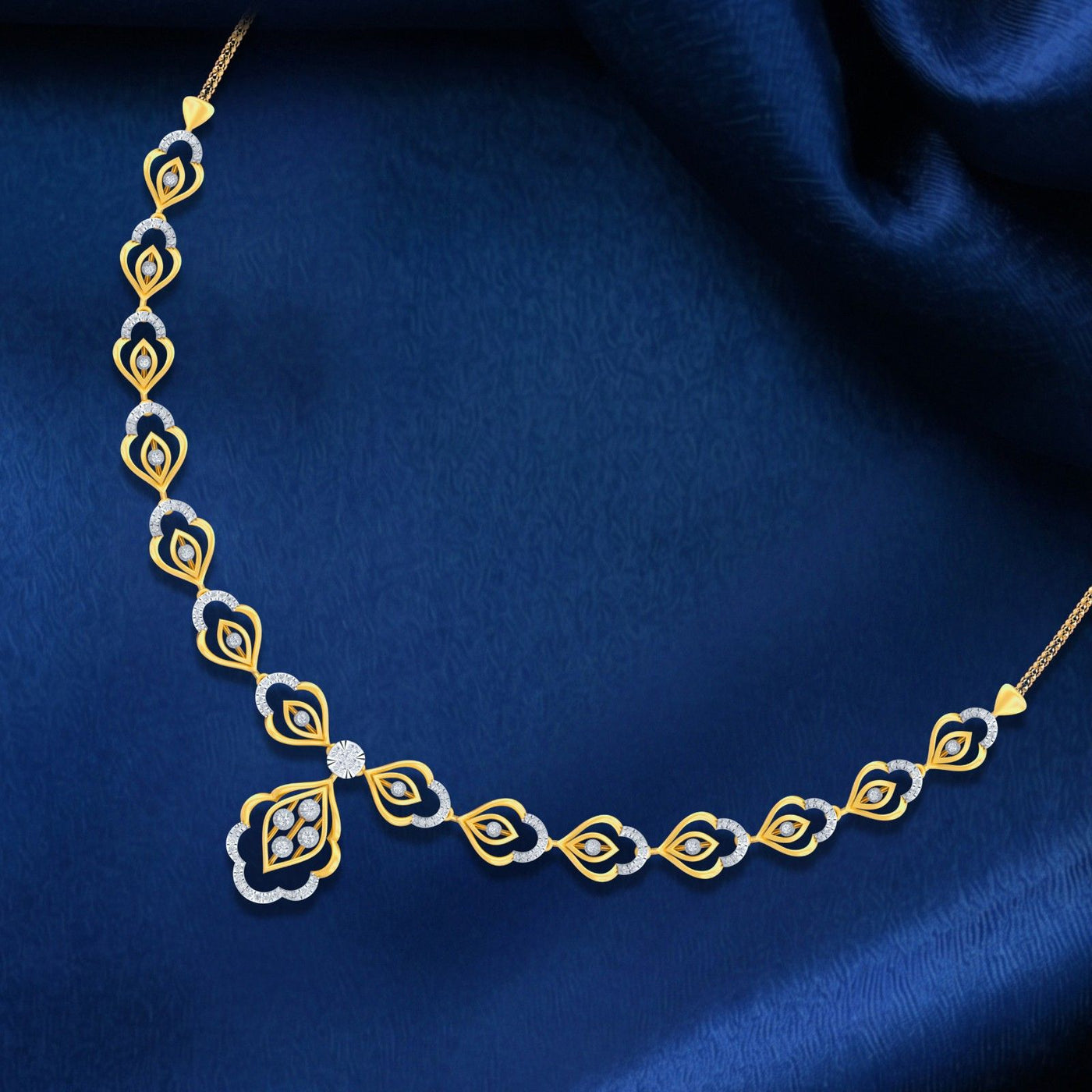 Gold and diamond necklace on a blue fabric background