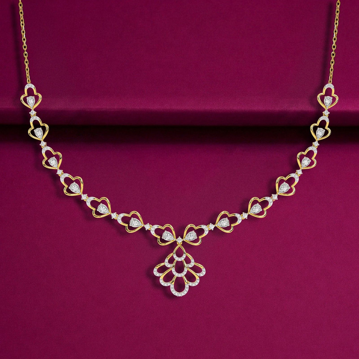 Gold and diamond floral necklace set, displayed on a deep magenta velvet background.