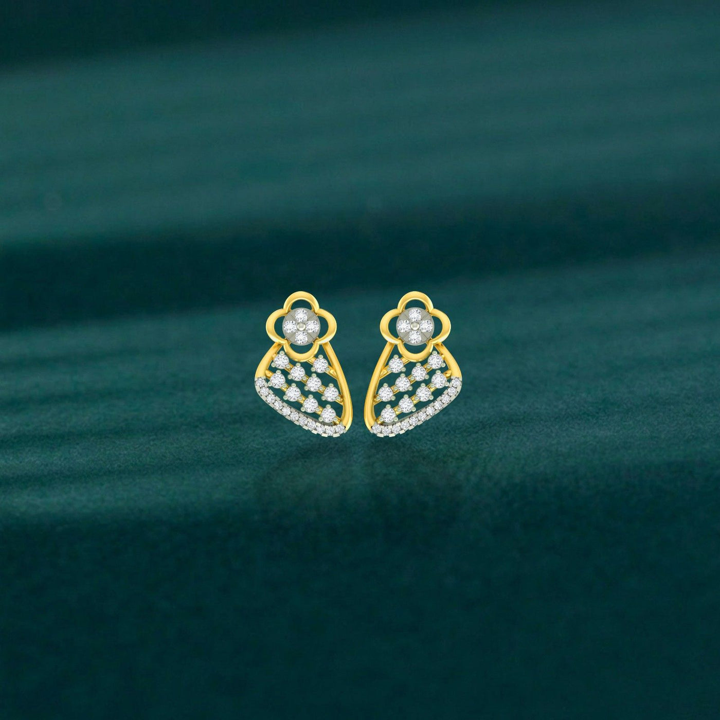 Pair of gold and diamond floral-design stud earrings on a teal background.