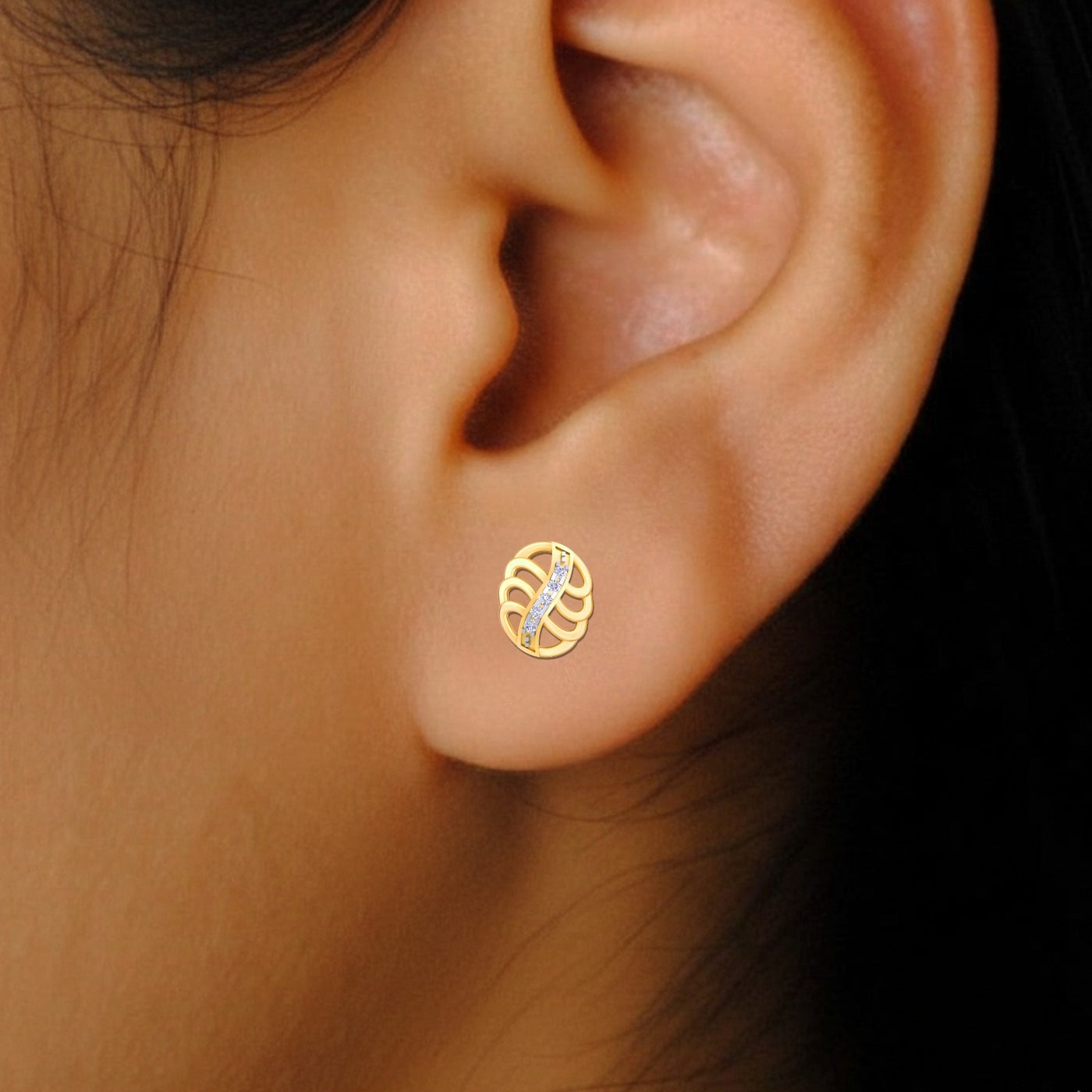Gold and diamond stud earrings , close-up shot.