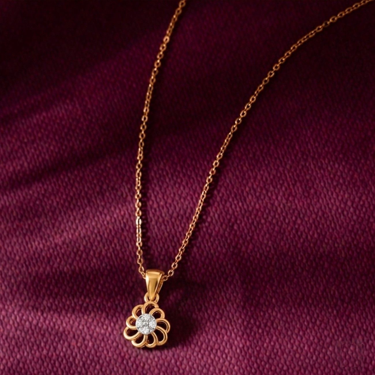 Gold necklace with a diamond pendant on a purple fabric background