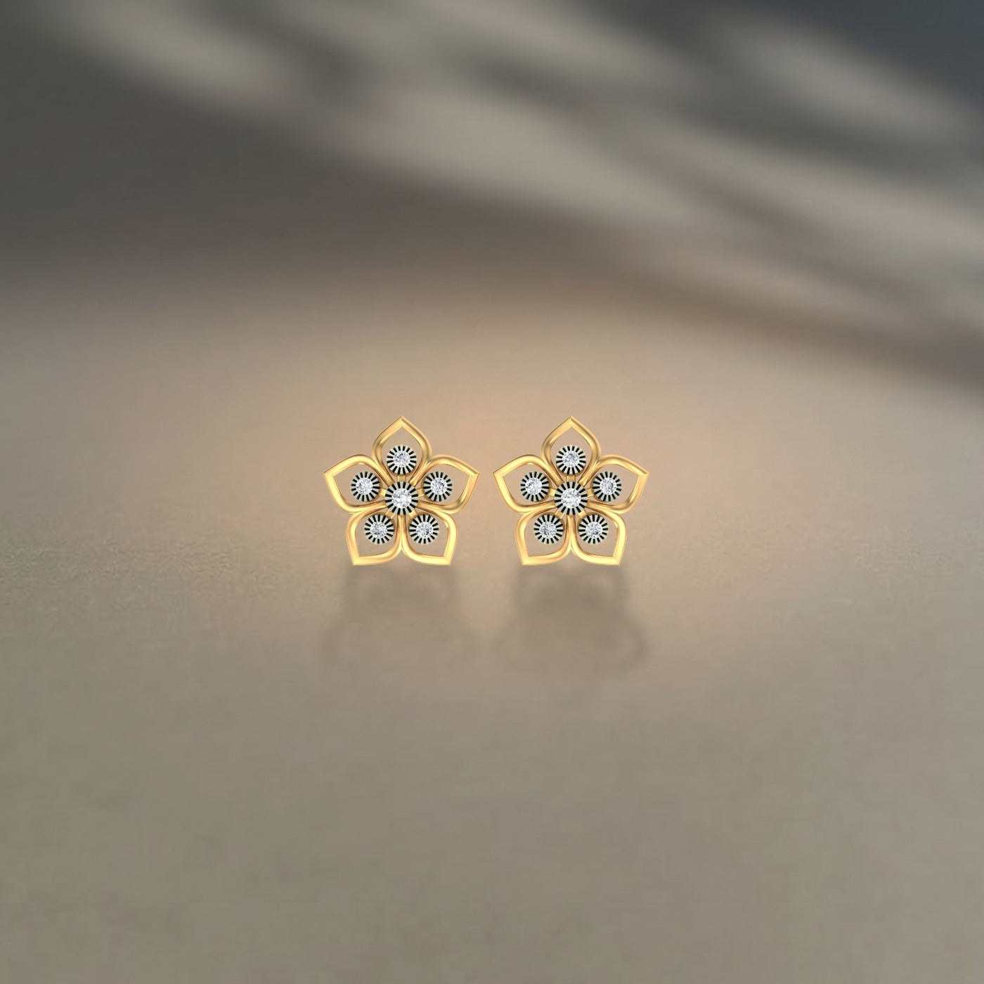 Gold and diamond floral-design stud earrings on a beige background.
