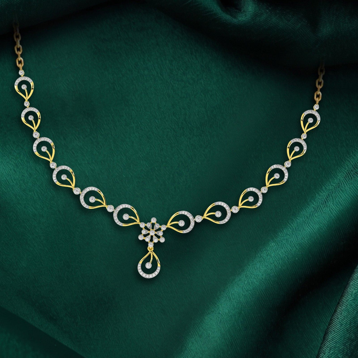 Delicate gold and diamond necklace on a green fabric background