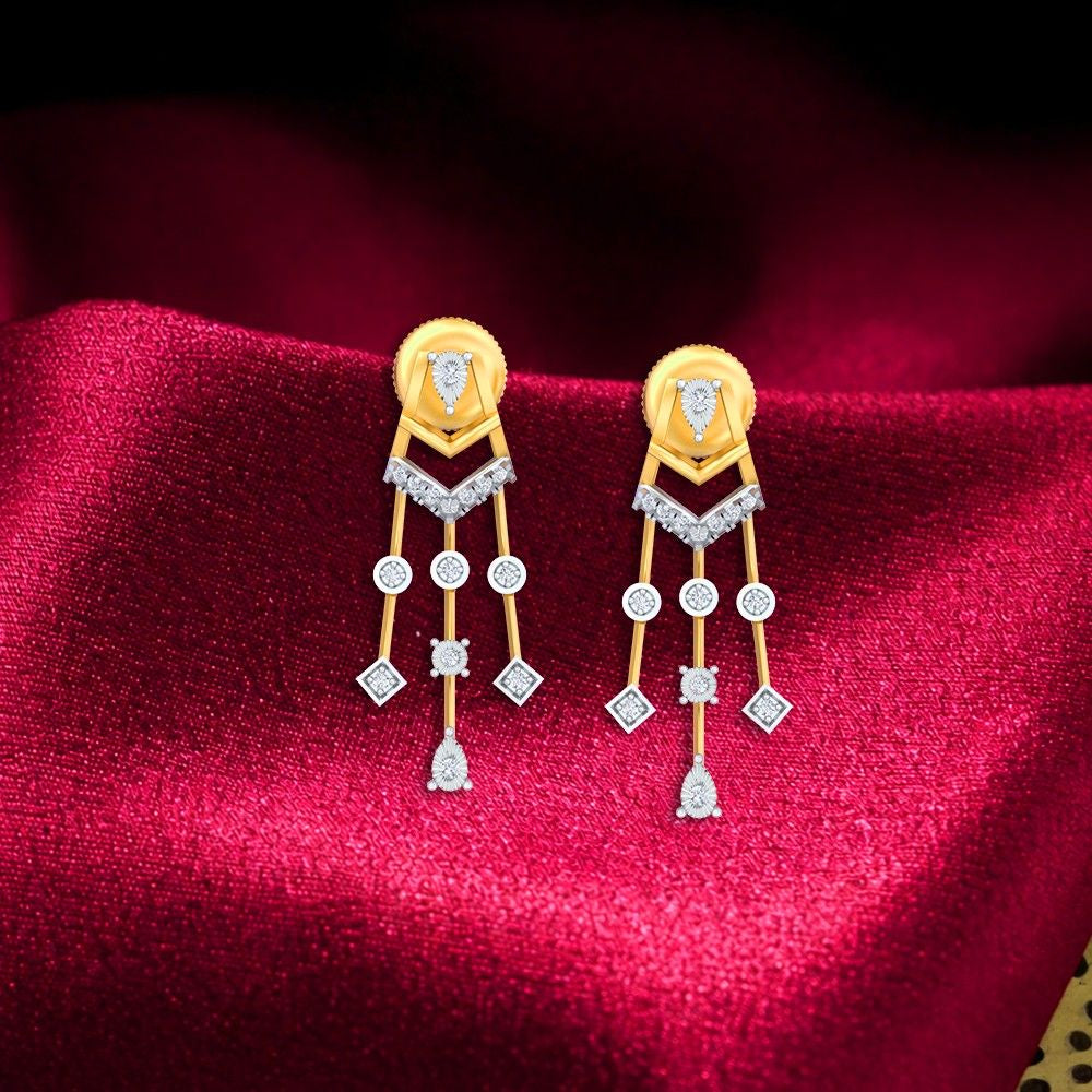 Gold and diamond earrings with intricate designs on a red fabric background.