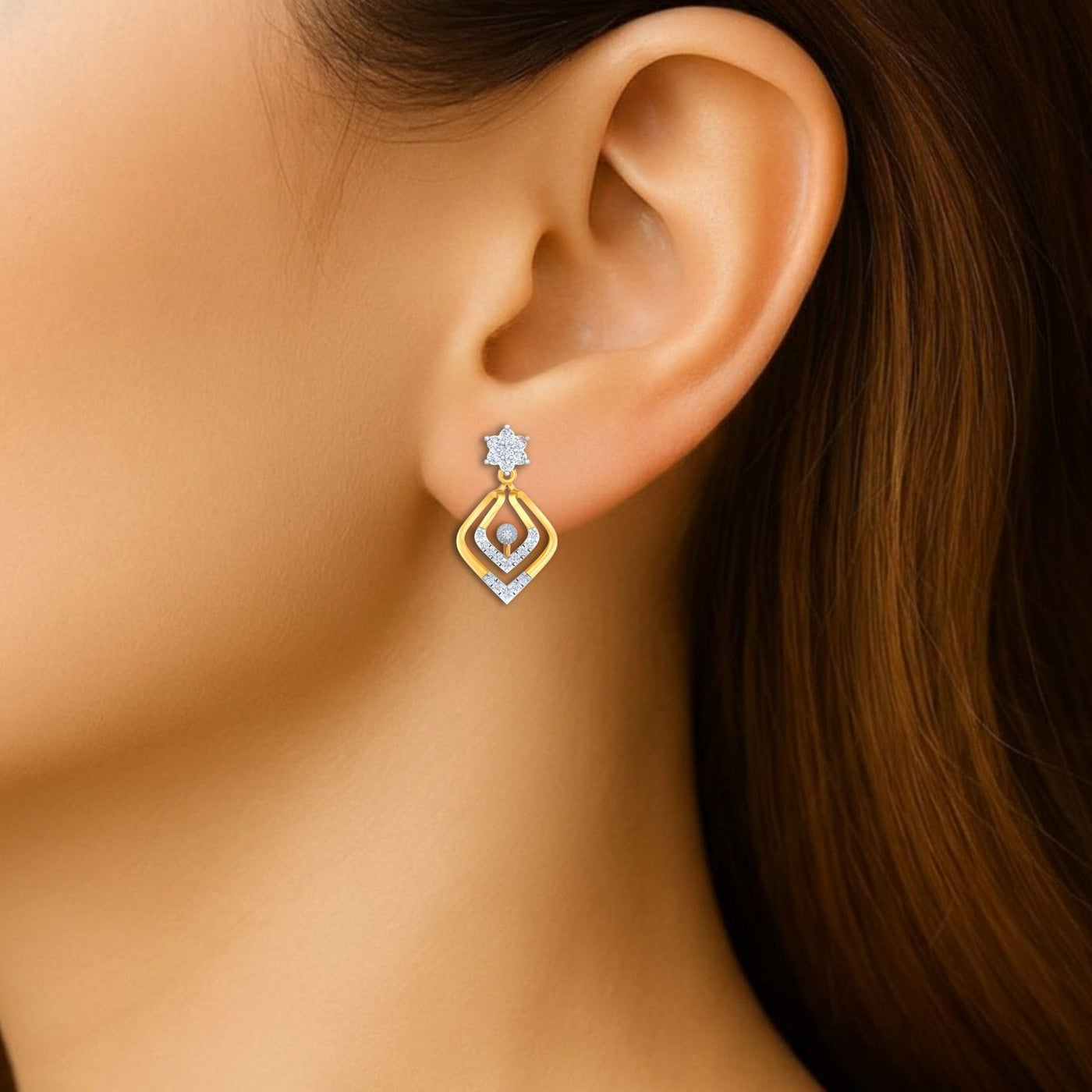 Close-up shot of a gold and diamond drop earrings.