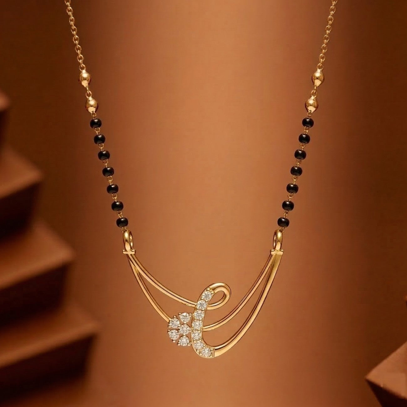 gold & diamond modern mangalsutra on brown background