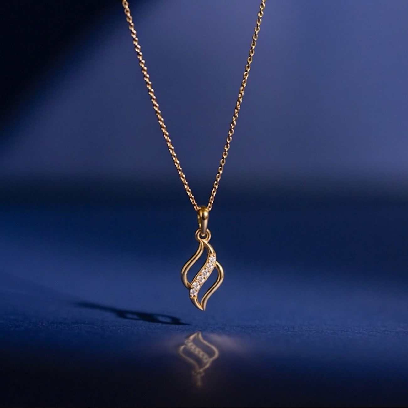 Gold and diamond pendant for women on blue background