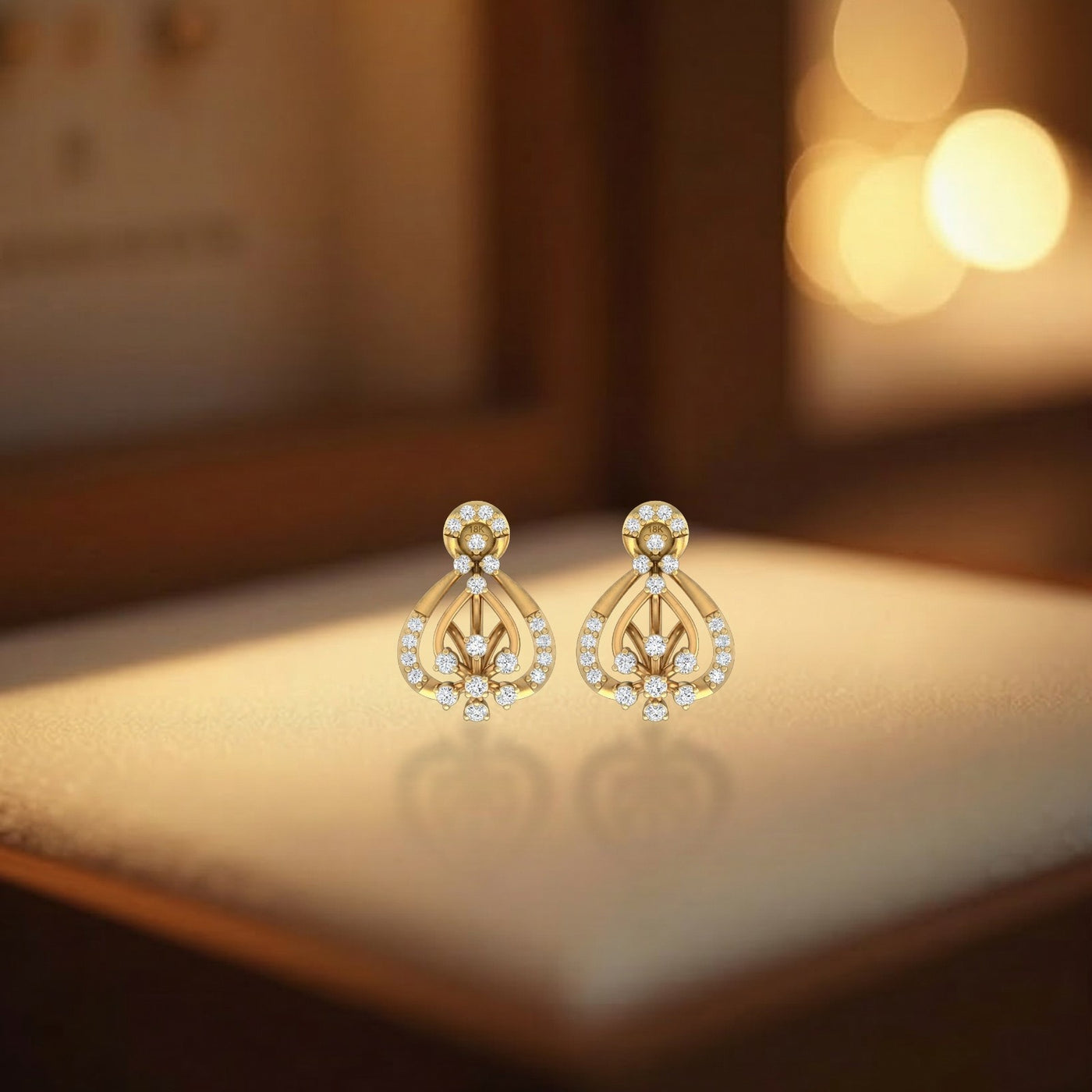 Gold and diamond stud earring with teardrop-shaped on a beige background.