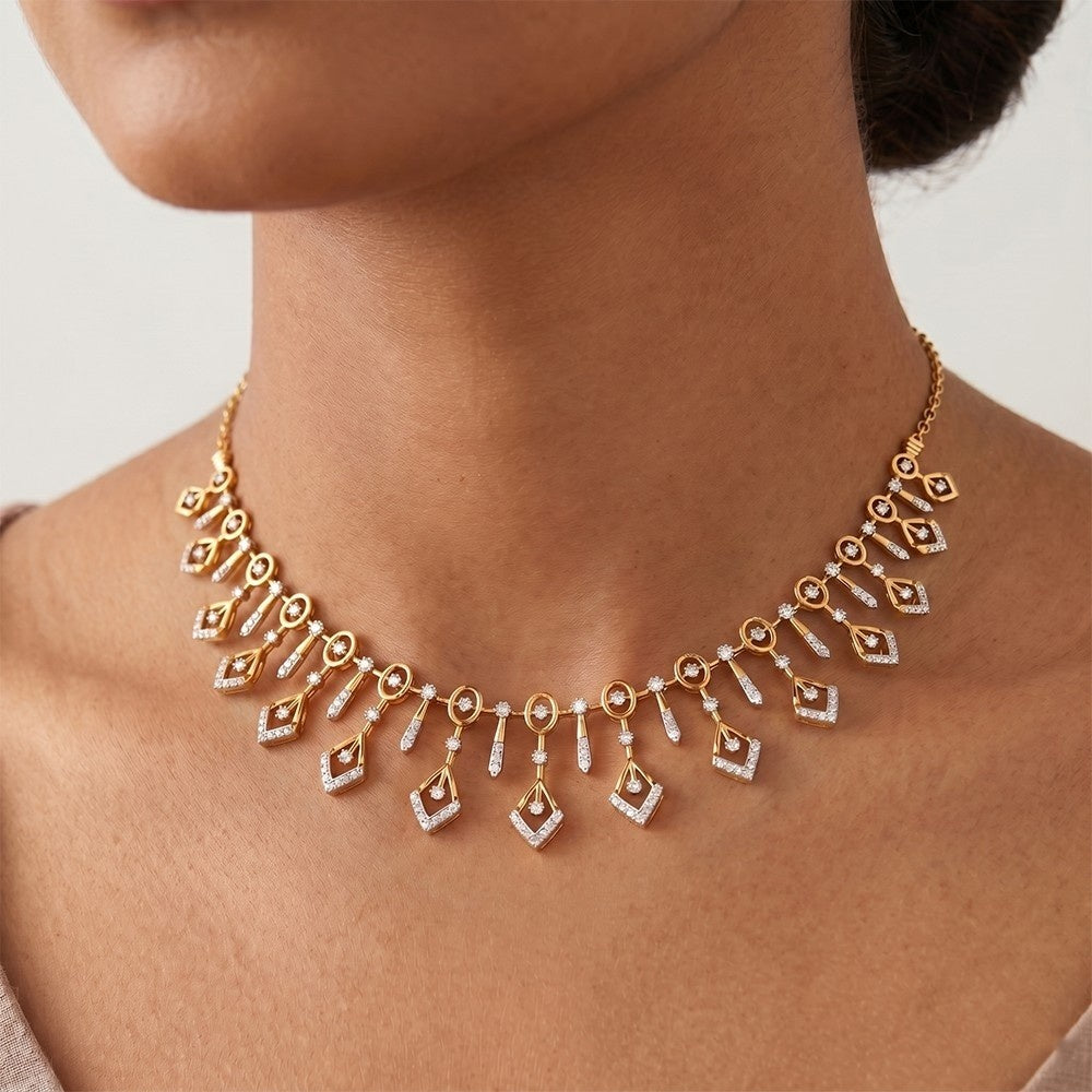 A gold and diamond necklace with multiple dangling diamond-shaped and teardrop motifs, shown worn on a model's neck.
