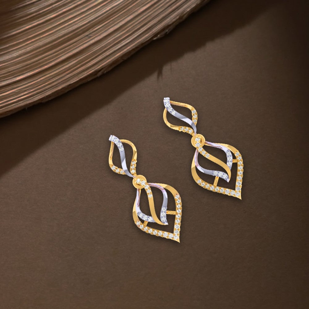 Pair of gold and diamond dangler earrings on a white brown