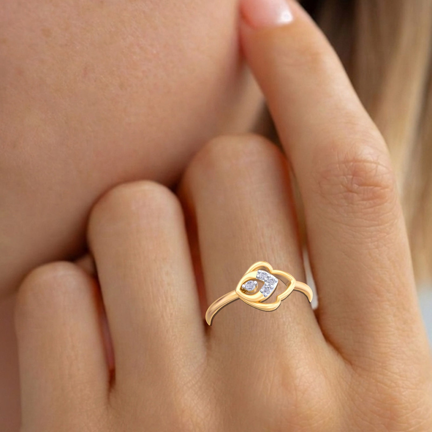 Gold ring with a diamond on a person's finger