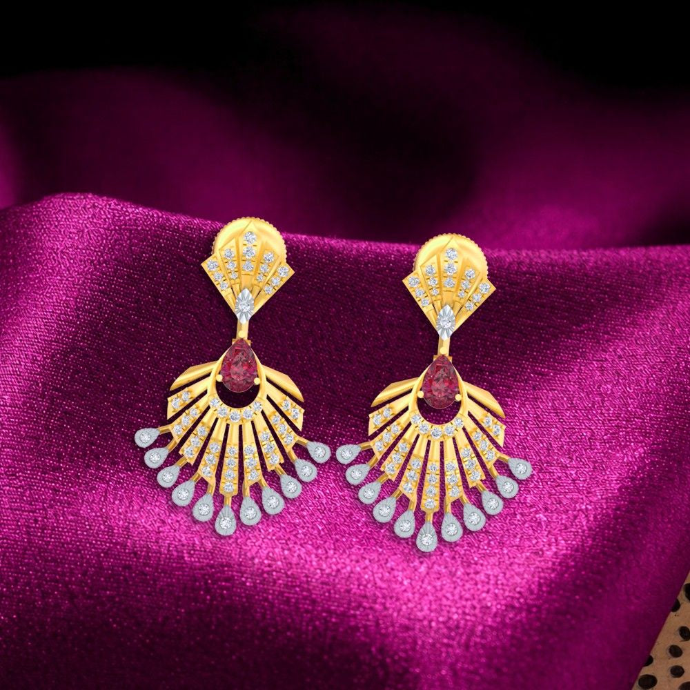 A pair of gold and diamond earrings with a floral design and a central ruby gemstone on a magenta fabric background.