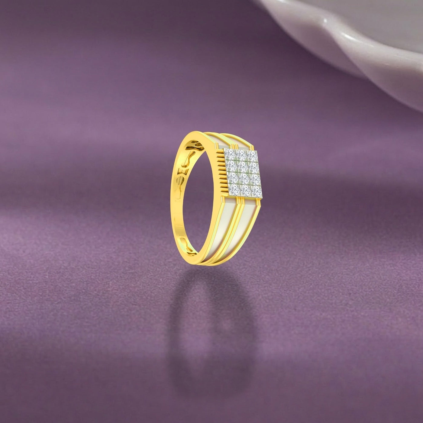 A gold ring with a square-shaped pavé diamond center and a textured, displayed on a purple surface.