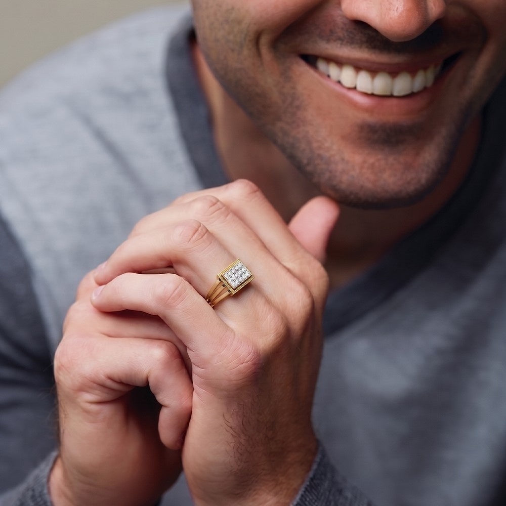 Man wearing a gold ring with a diamond on his finger.