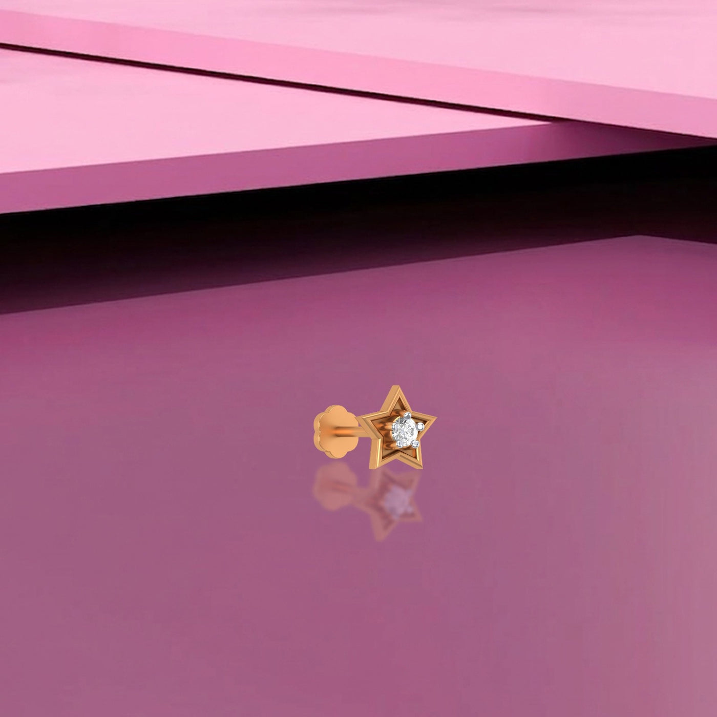 Yellow Gold and diamond nose pin with a diamond on a pink background