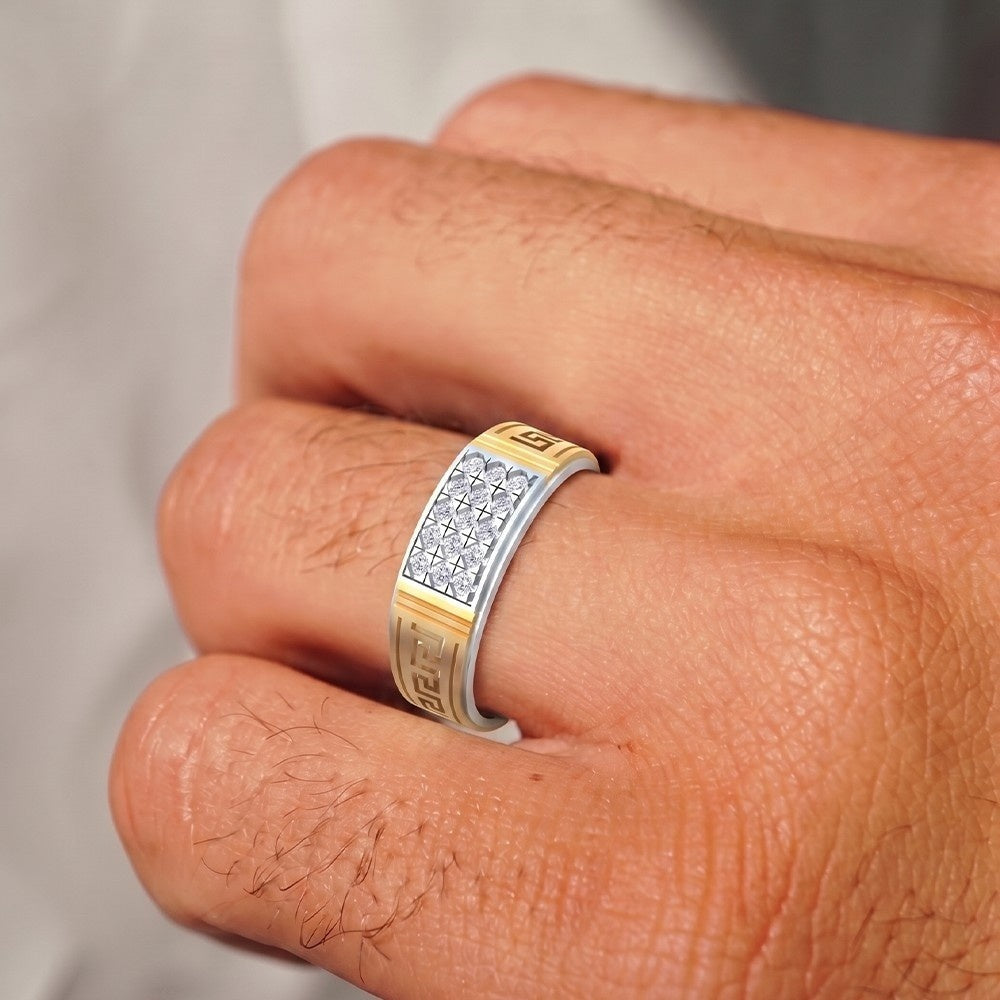 Gold and diamond ring with diamonds on a finger against a neutral background
