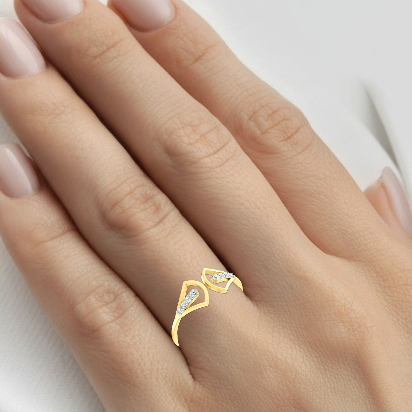 Gold ring with a diamond on a hand against a white background