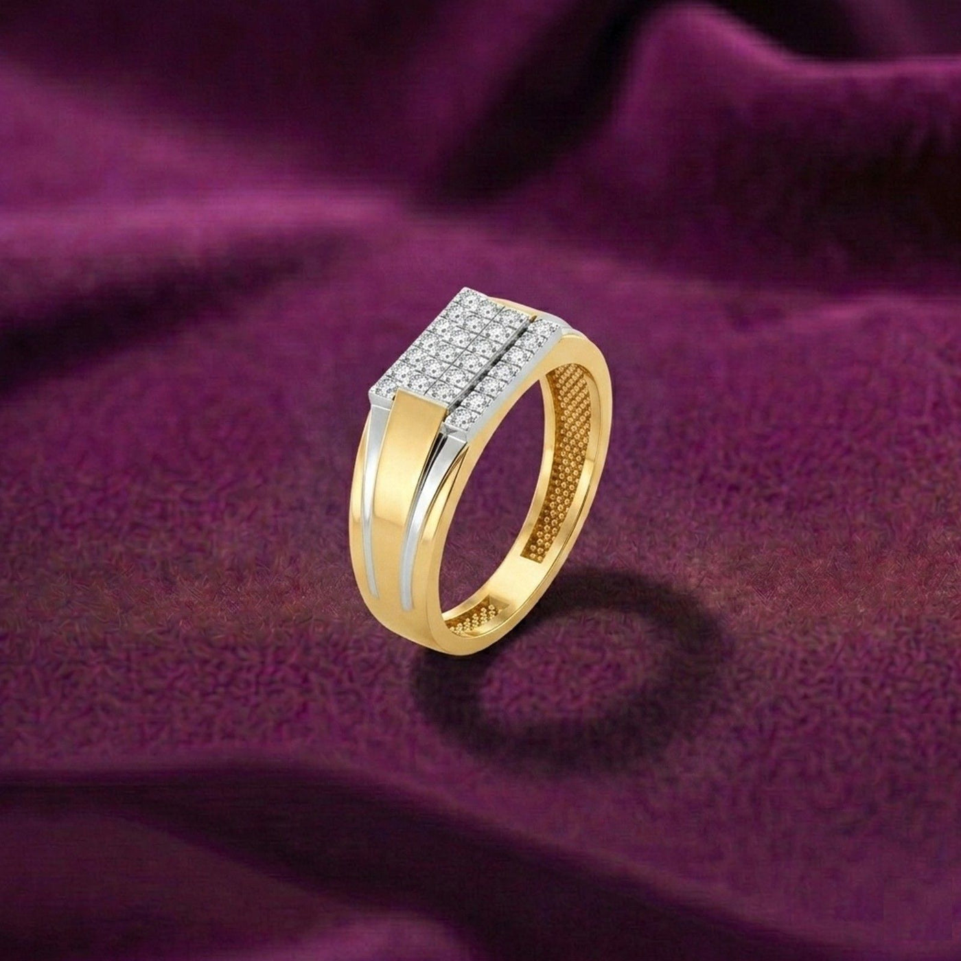 Gold and silver ring on a purple fabric background.