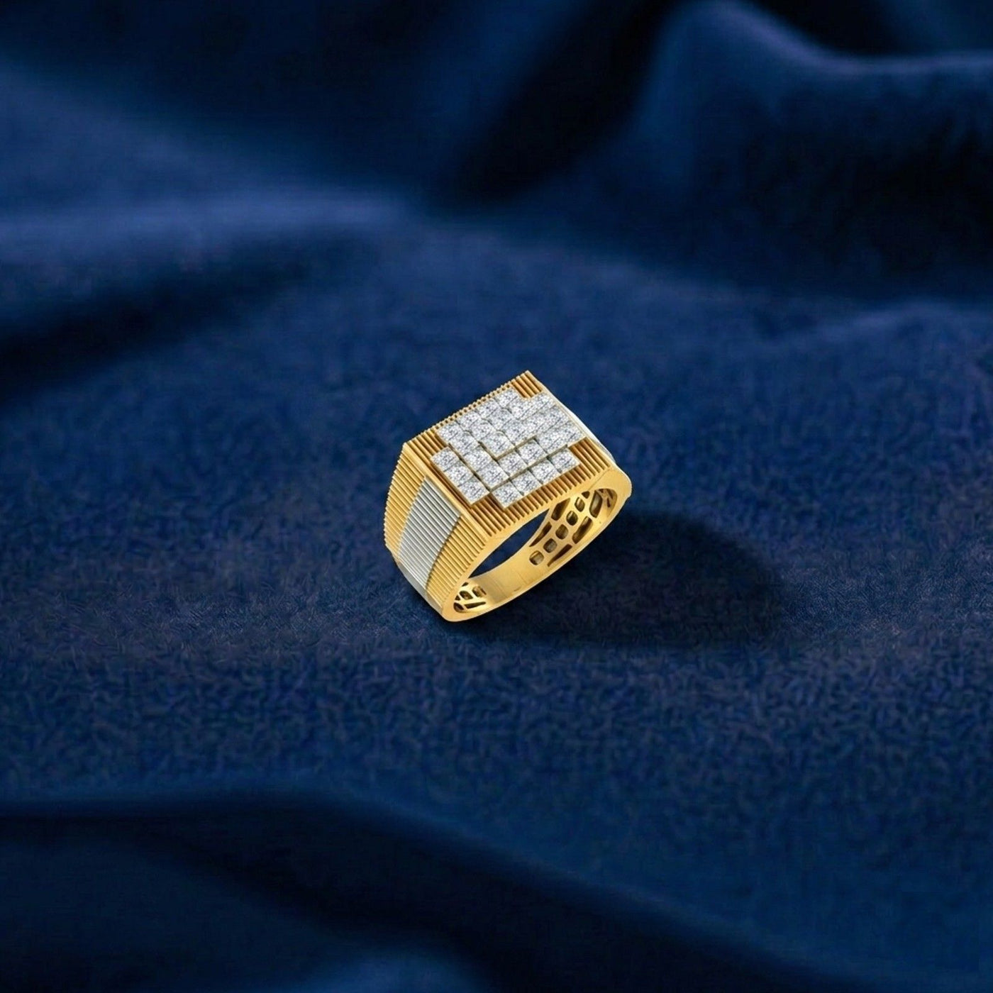 Gold ring with diamonds on a blue textured fabric background