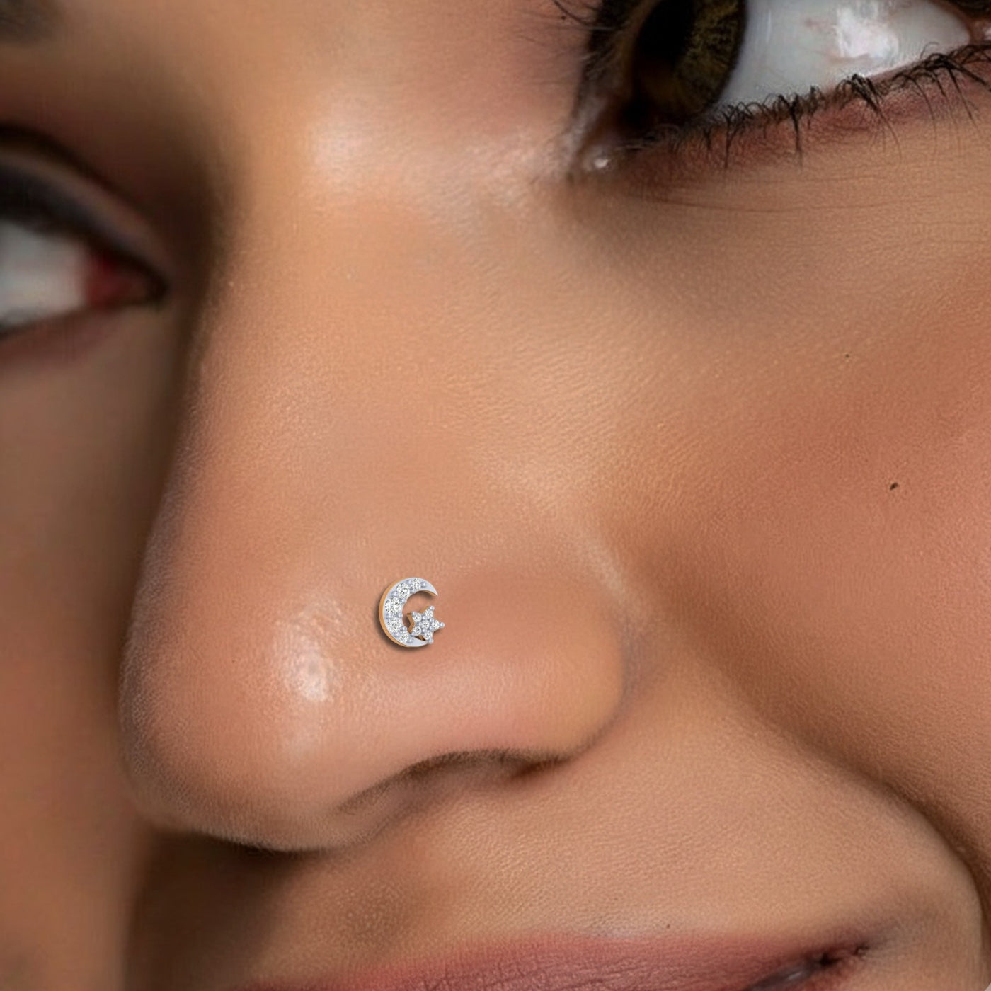 Close-up of a person wearing a gold and diamond nose ring.