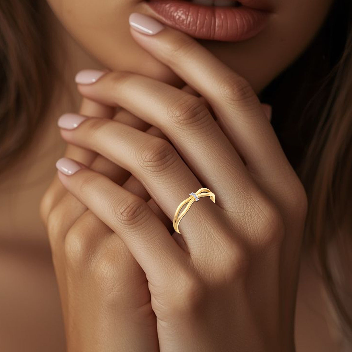 Close-up of a hand wearing a gold ring with a blurred background