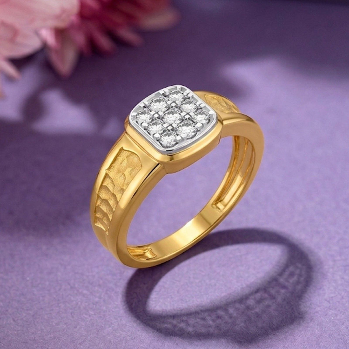 Gold ring with diamond accent on a purple background