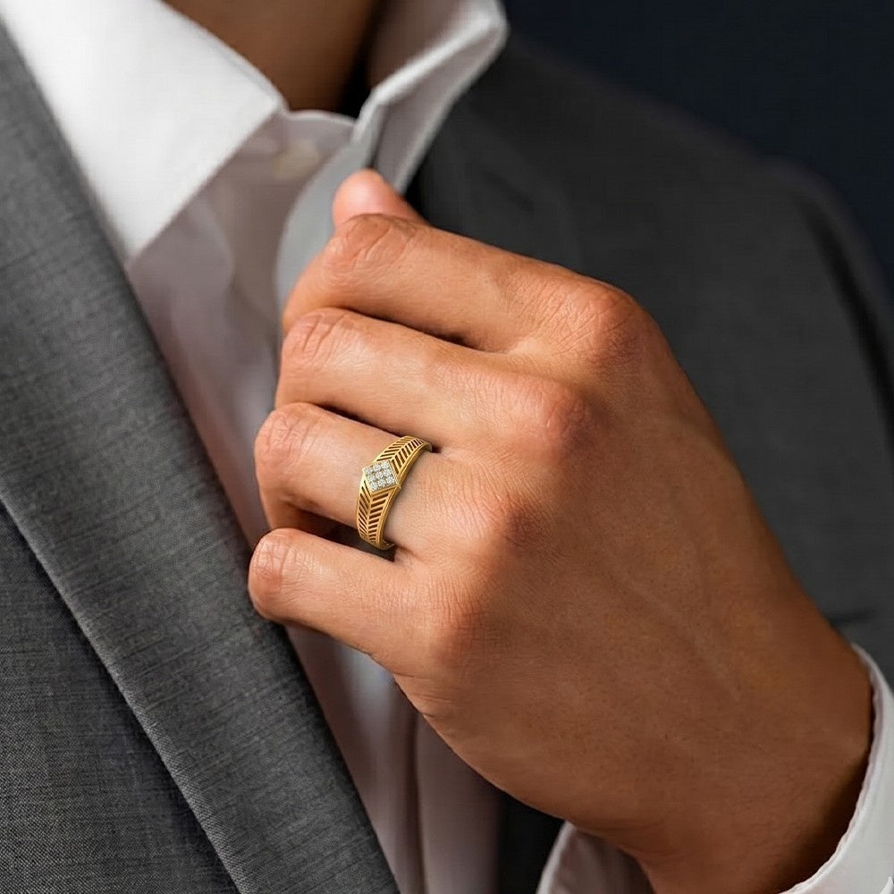 Hand wearing a gold ring with a gray suit and white shirt in the background.