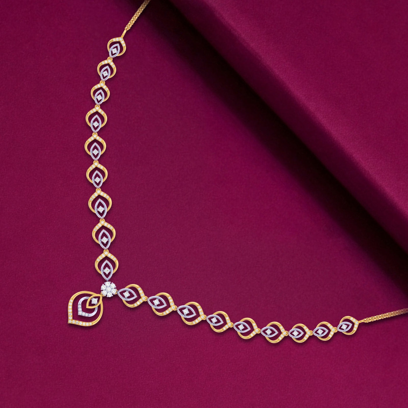 Gold necklace with a diamond on a red fabric background