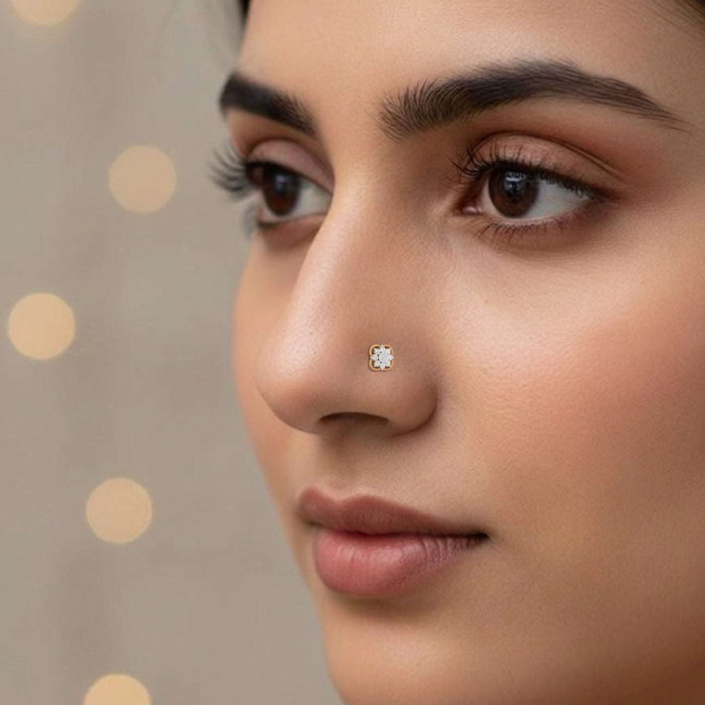 Close-up of a woman's face with a diamond nose pin against a neutral background