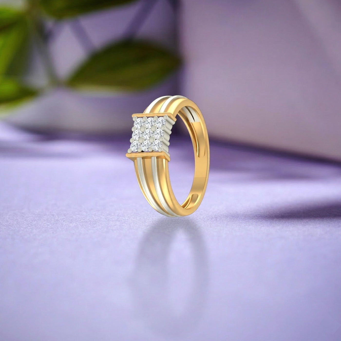 Gold ring with diamond accents on a purple surface.