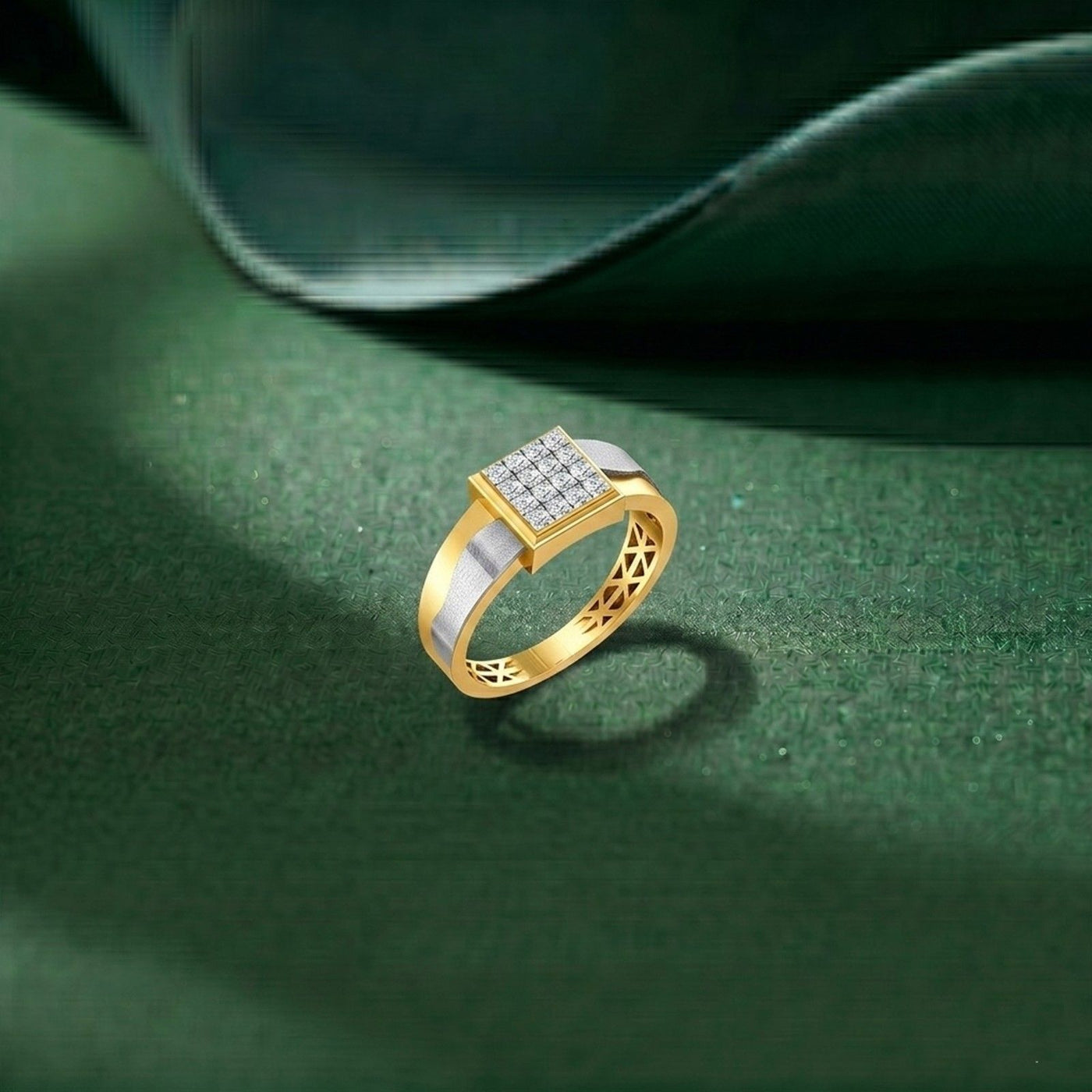 Gold ring with diamond accents on a green textured surface.