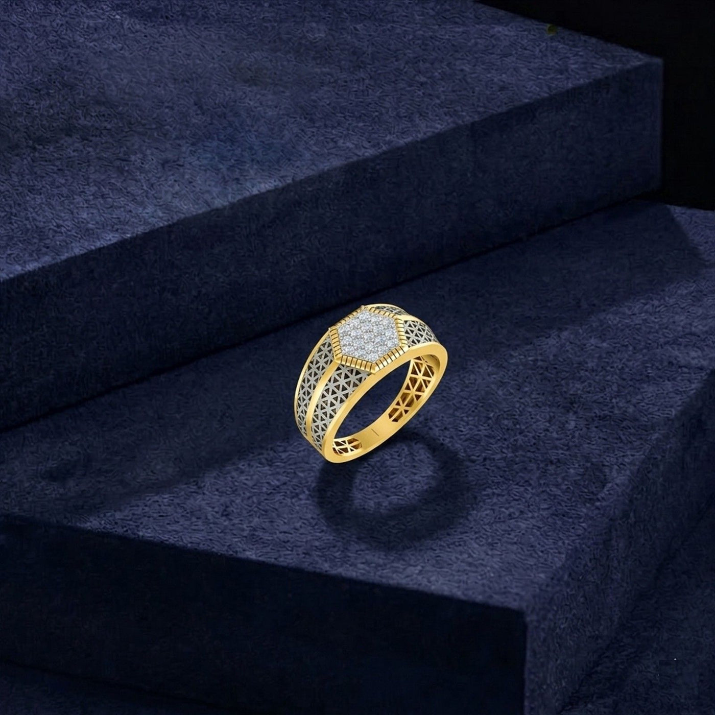 A gold ring with a geometric filigree design and a central cluster, displayed on a dark textured pedestal.
