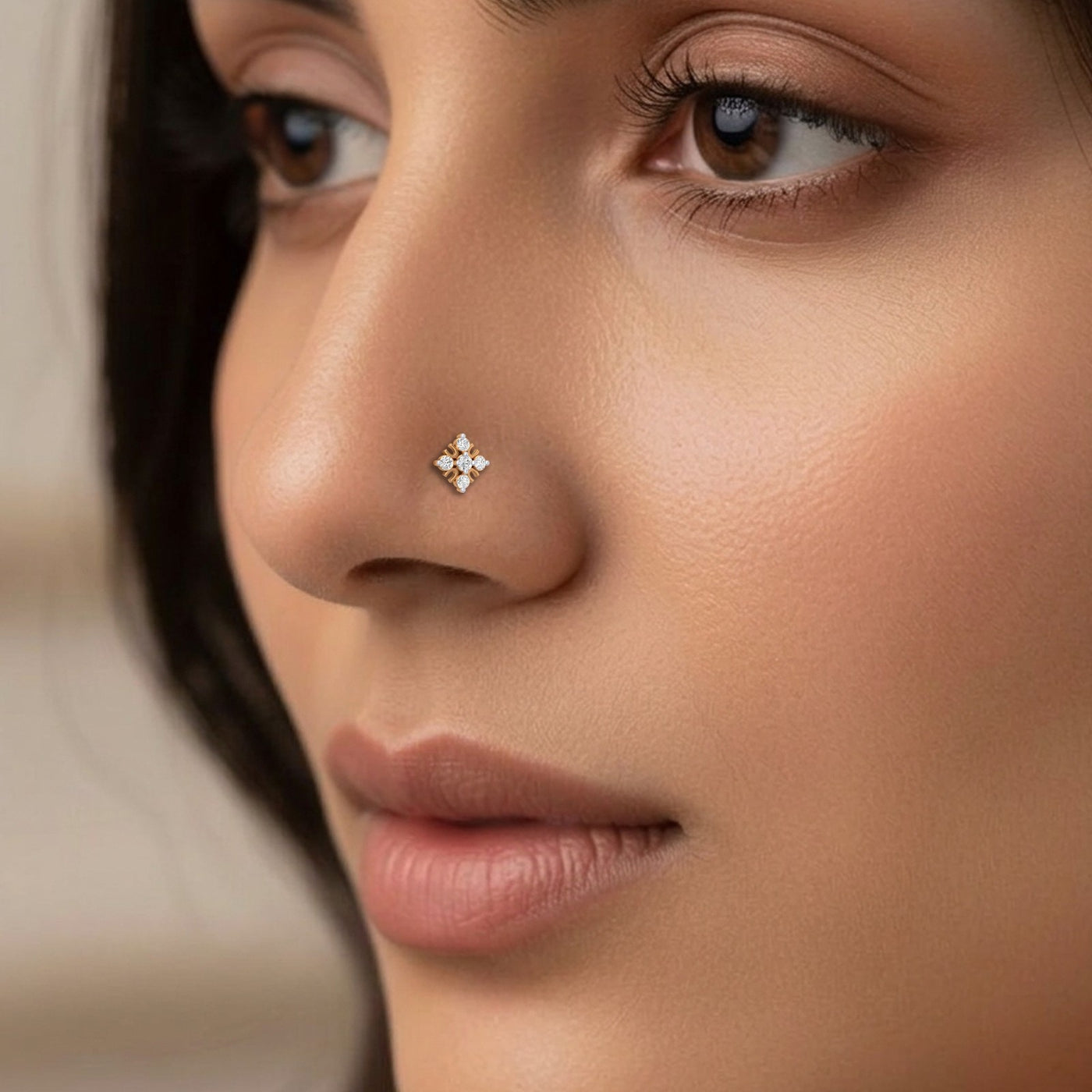Close-up of a woman's face with a diamond nose pin.