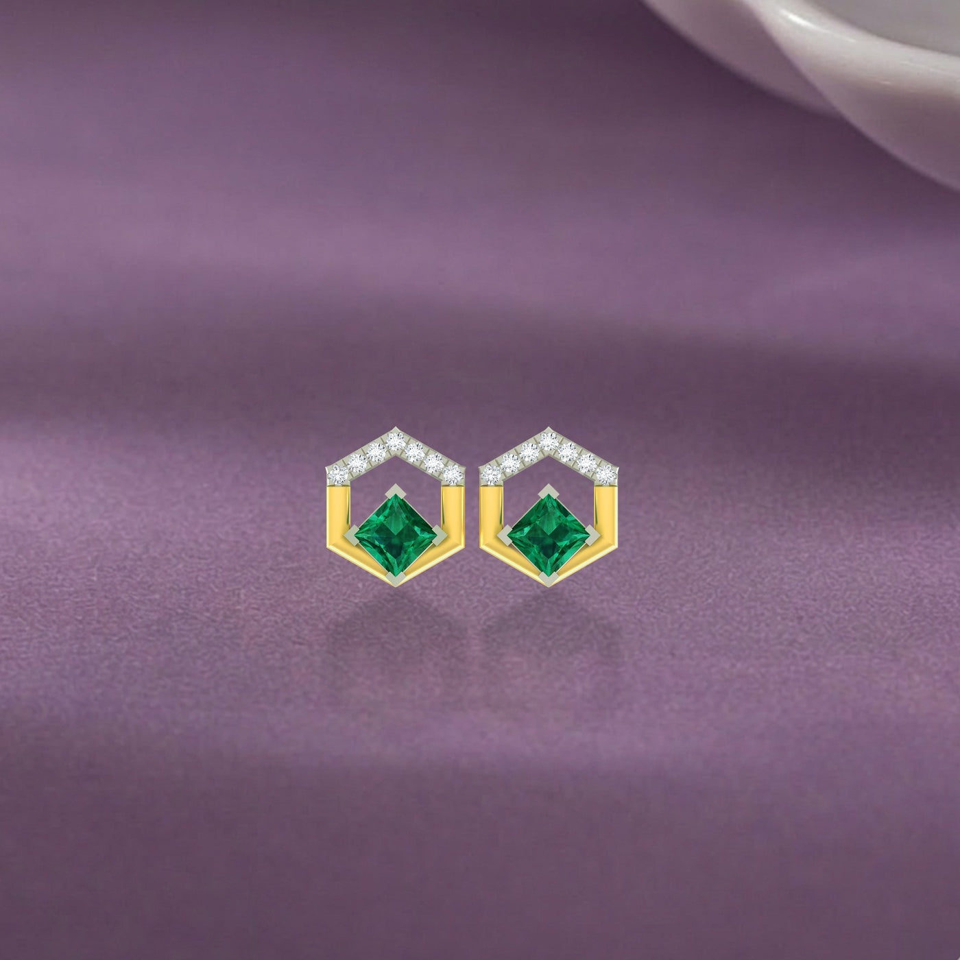 A pair of geometric, two-tone gold open-hexagon earrings featuring central square green gemstones earring