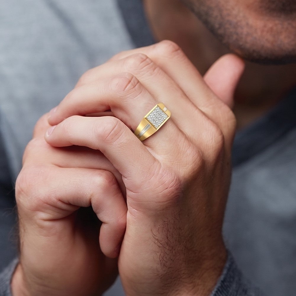 Close-up of a hand wearing a gold ring with diamond accents.