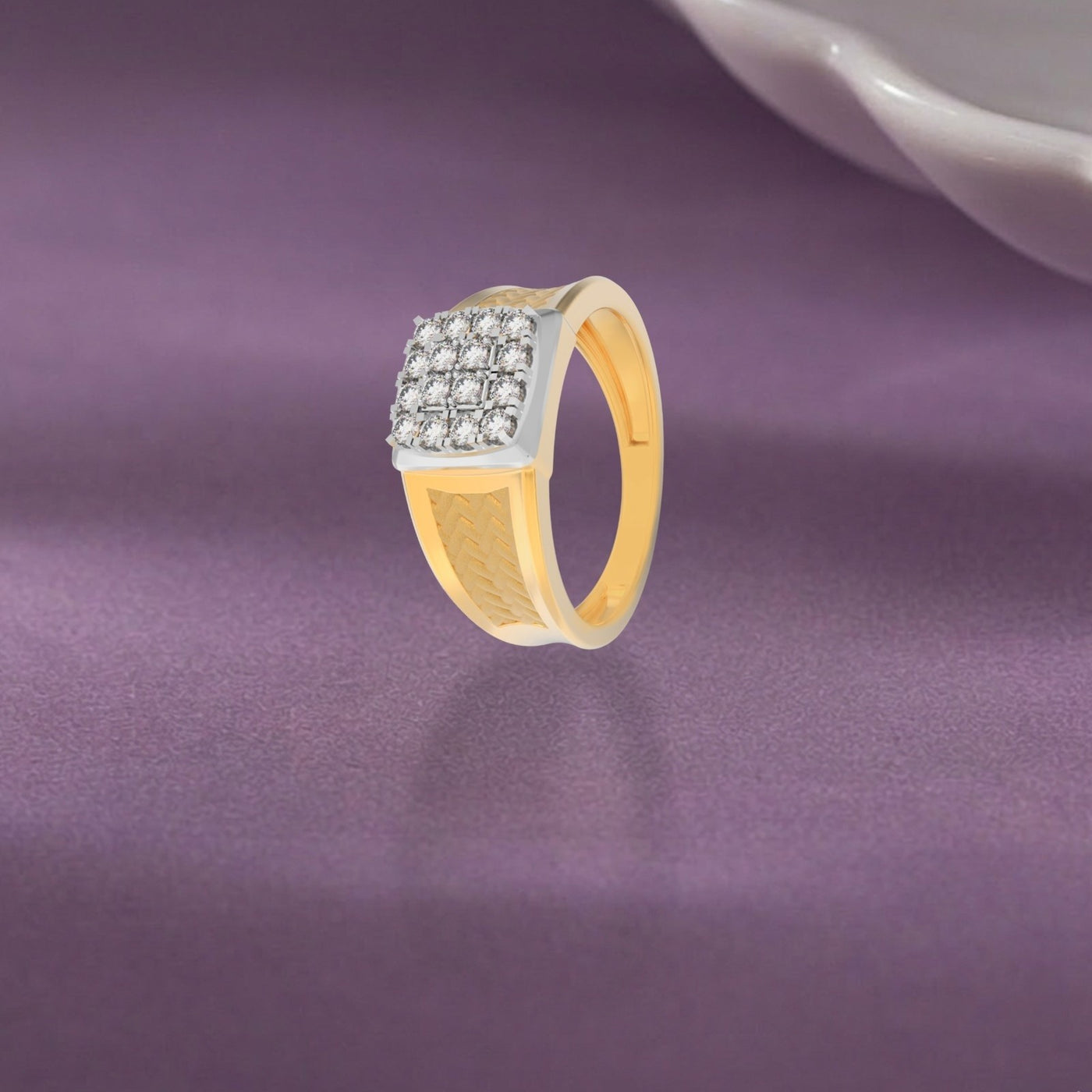 Gold ring with diamonds on a purple fabric background.