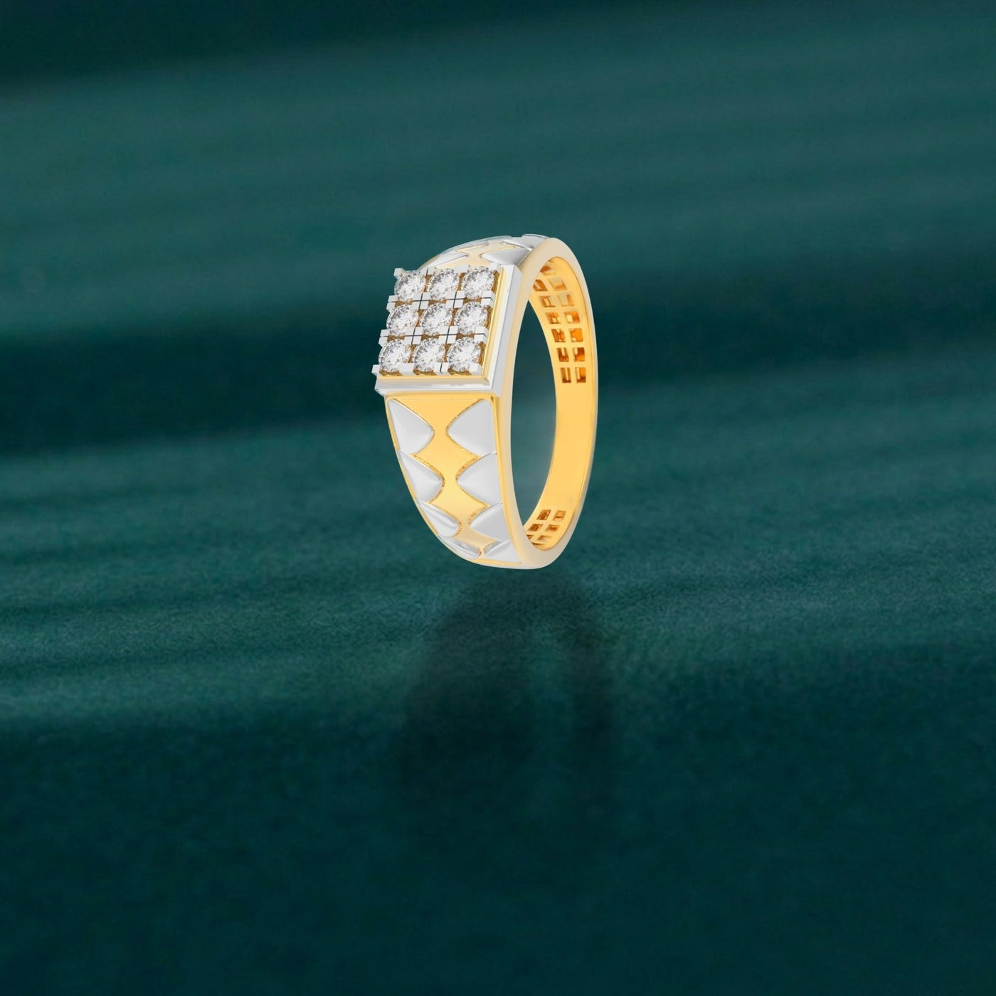 Gold and diamond ring with diamond accents on a green textured background
