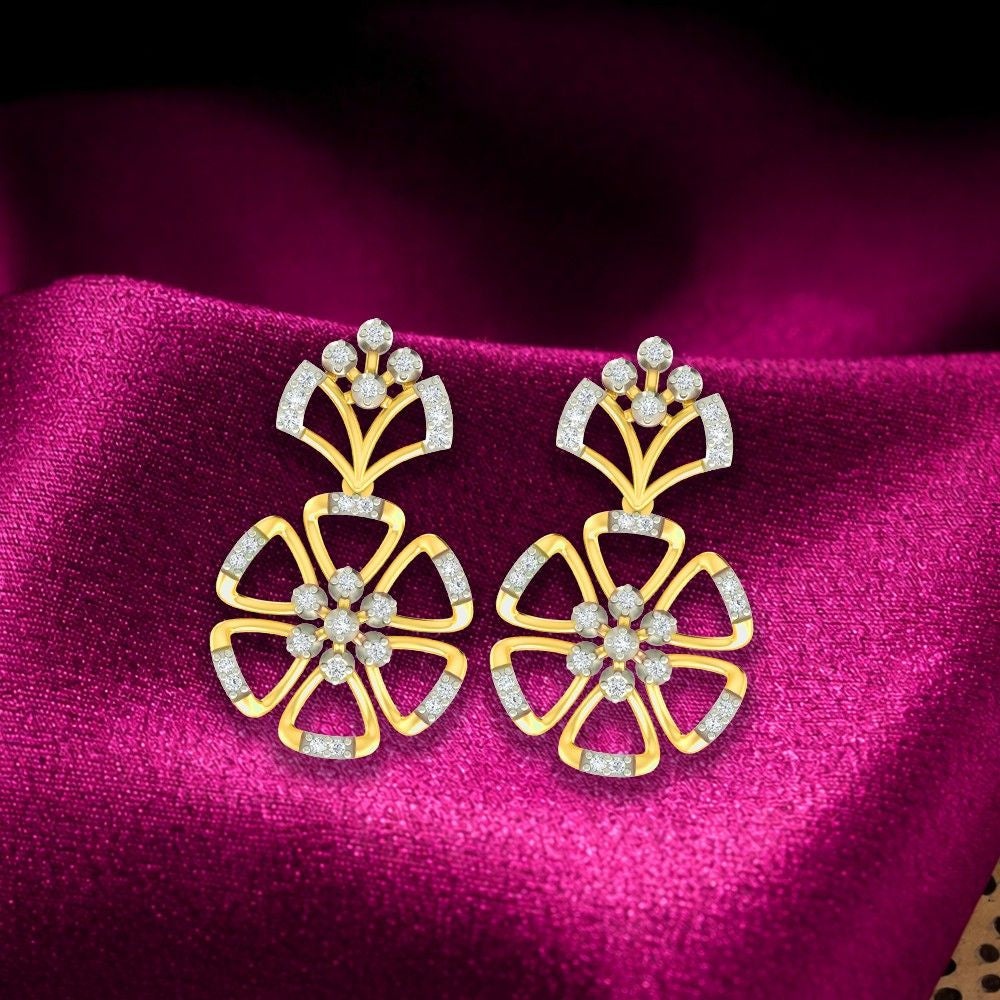 Gold and diamond floral earrings on a magenta fabric background