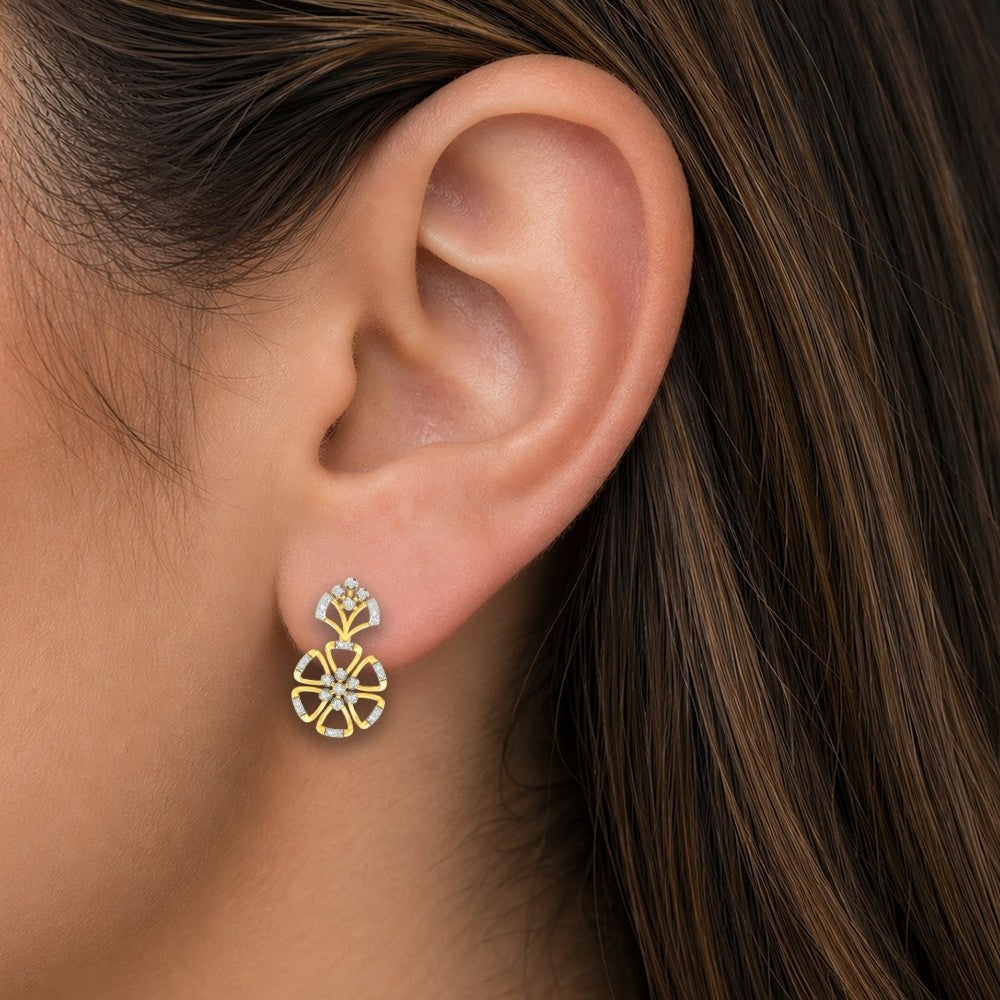 Close-up shot of a gold and diamond floral earrings on a white background