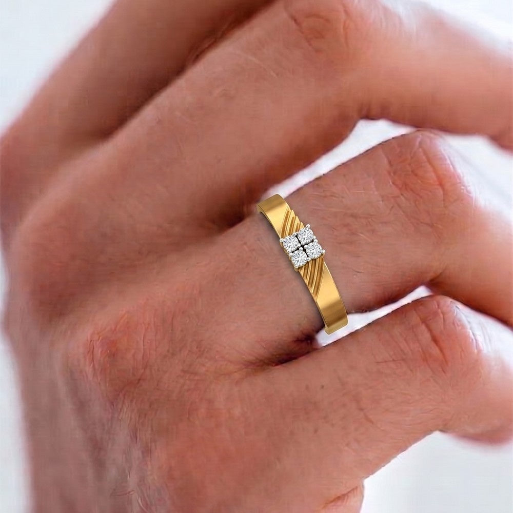 Gold ring with a diamond on a person's finger against a white background.