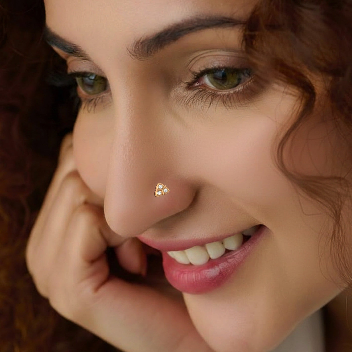 Close-up of a woman with a small decorative object on her nose pin.