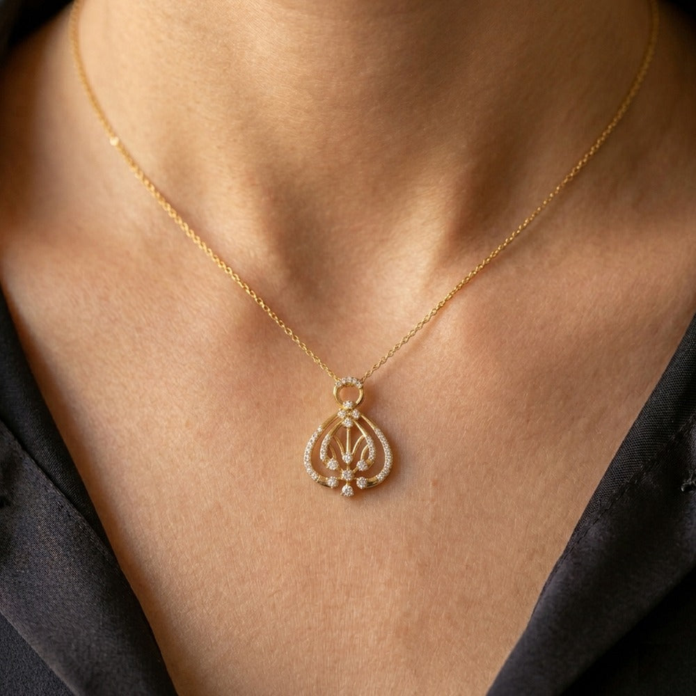 Women wearing gold and diamond pendant 