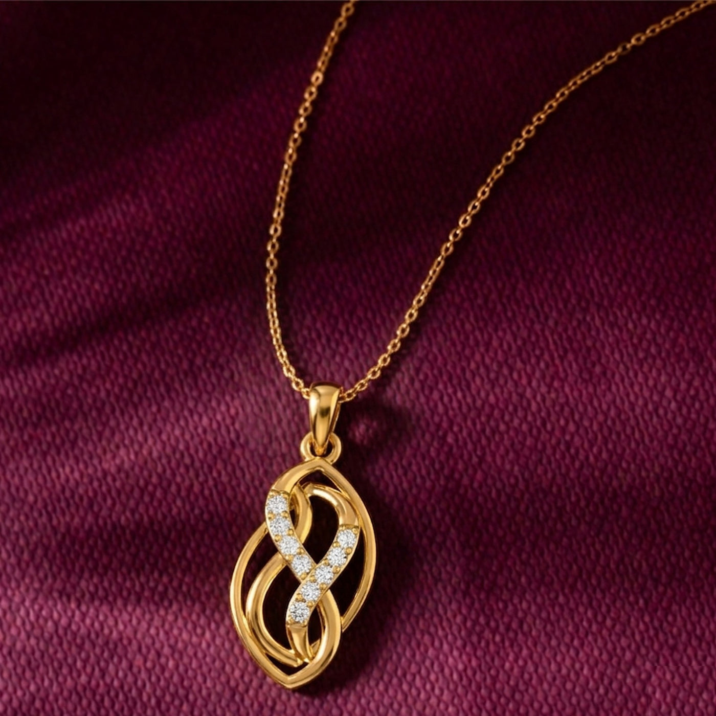 Gold necklace with a intricate pendant on a purple fabric background