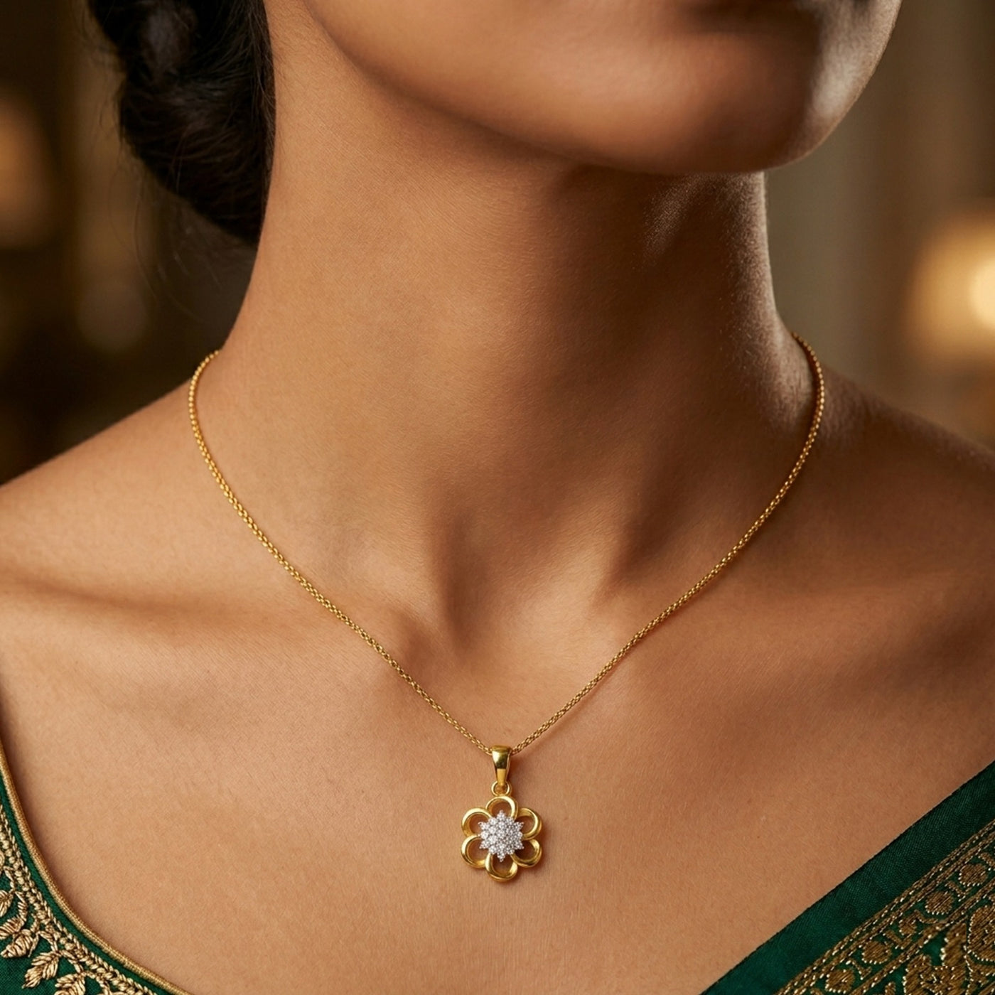 Gold and diamond with a floral pendant on a person wearing a green traditional outfit.